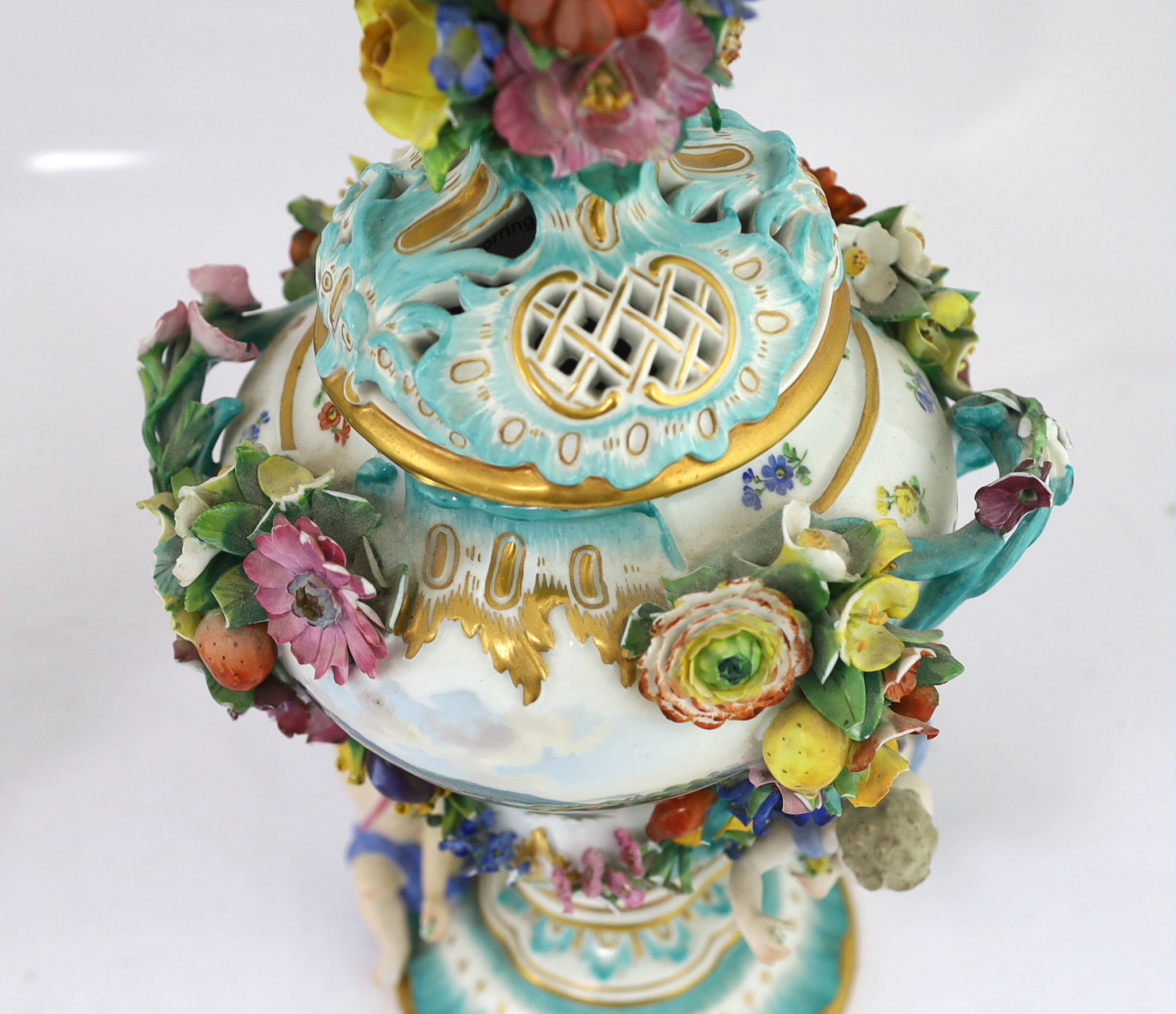A pair of Meissen topographical flower encrusted vases and covers, 19th century, losses